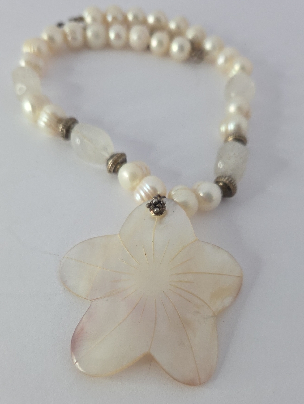 Mother of pearl flower pendant necklace featuring white pearls & stone beads